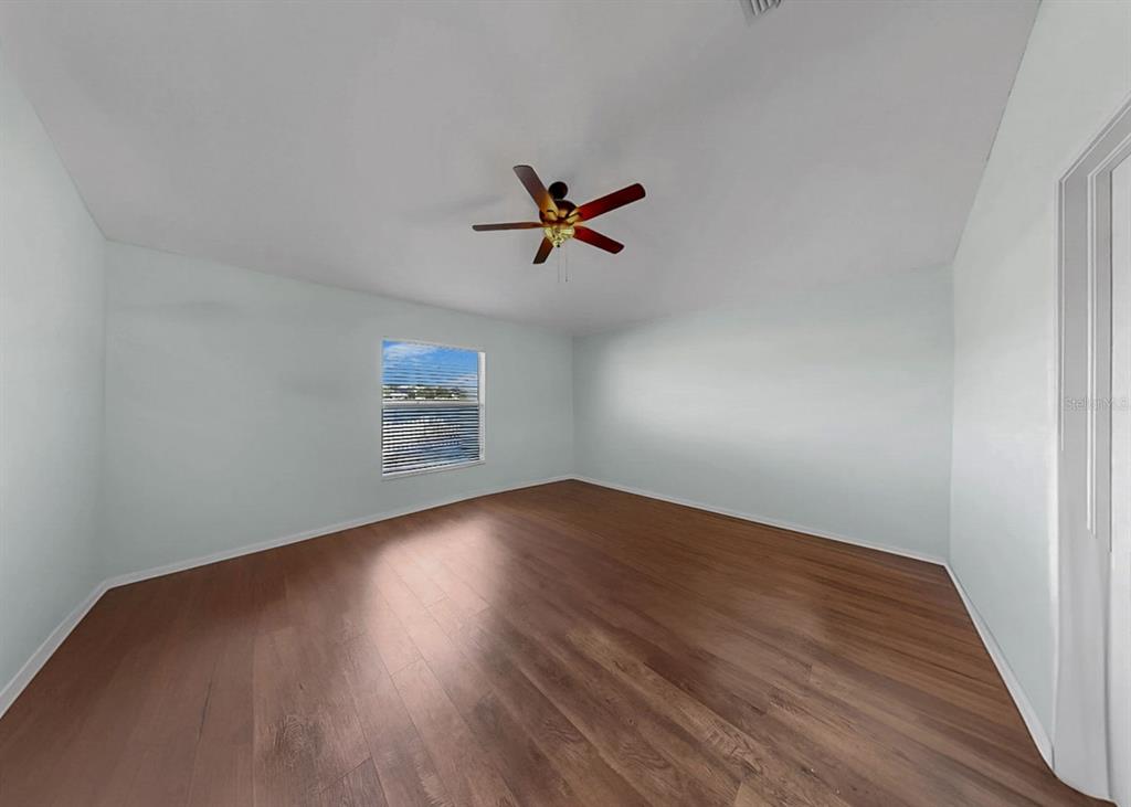 2310 Potomac Mark Place Ruskin, FL 33570 - Photo 20 of 40 an empty room with wooden floor and ceiling fan