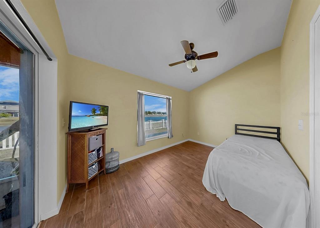 2310 Potomac Mark Place Ruskin, FL 33570 - Photo 22 of 40 a view of an empty room with a window and wooden floor