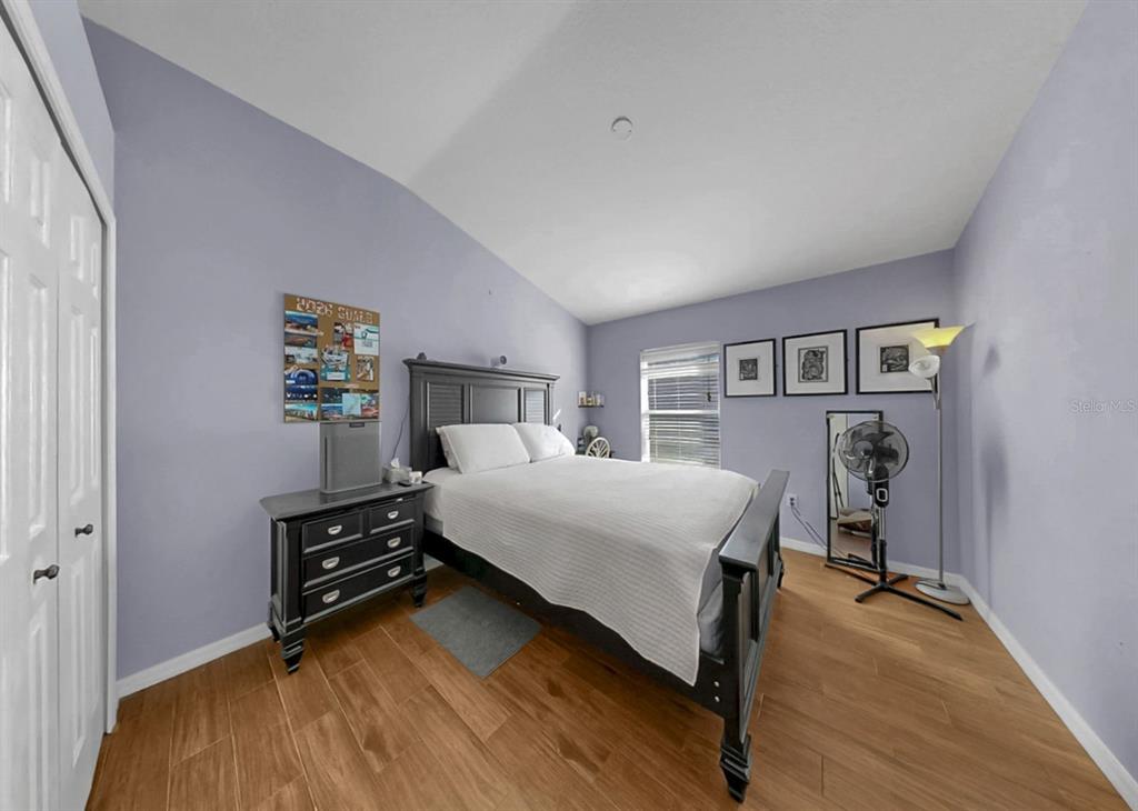 2310 Potomac Mark Place Ruskin, FL 33570 - Photo 25 of 40 a bedroom with a bed and a chandelier