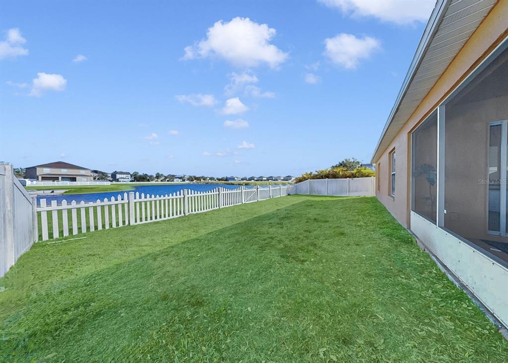 2310 Potomac Mark Place Ruskin, FL 33570 - Photo 31 of 40 a view of a green field with wooden fence