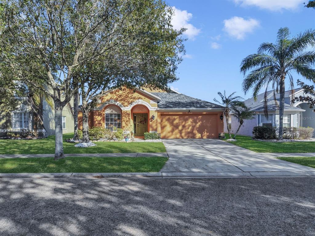 2310 Potomac Mark Place Ruskin, FL 33570 - Photo 37 of 40 a front view of a house with garden and trees