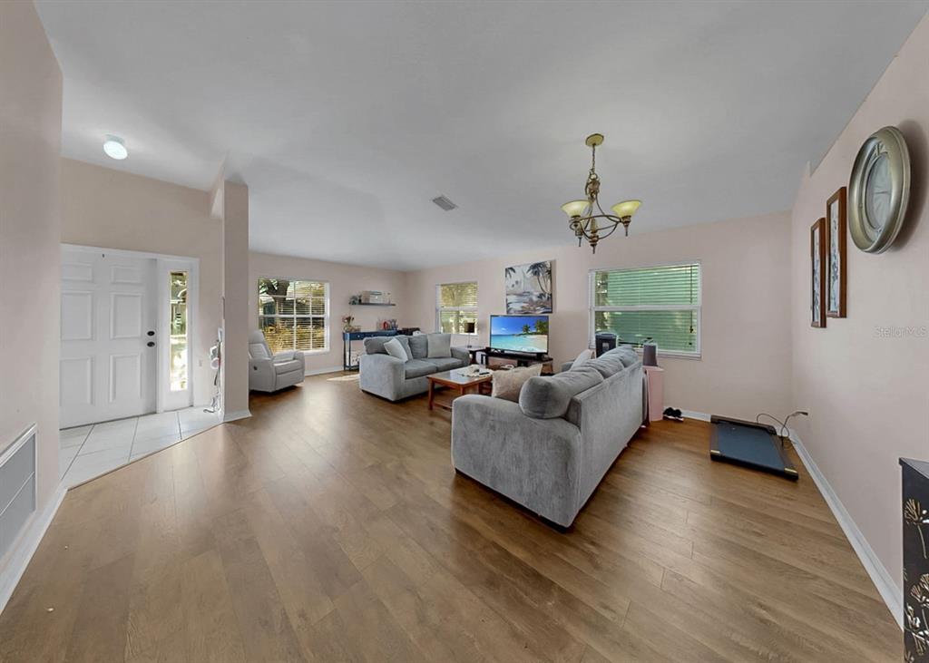 2310 Potomac Mark Place Ruskin, FL 33570 - Photo 4 of 40 a living room with furniture and a chandelier