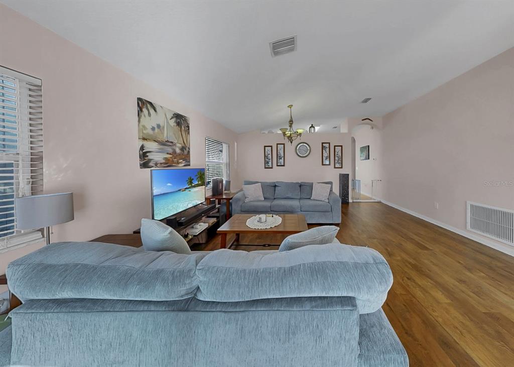 2310 Potomac Mark Place Ruskin, FL 33570 - Photo 5 of 40 a bedroom with a bed and wooden floor