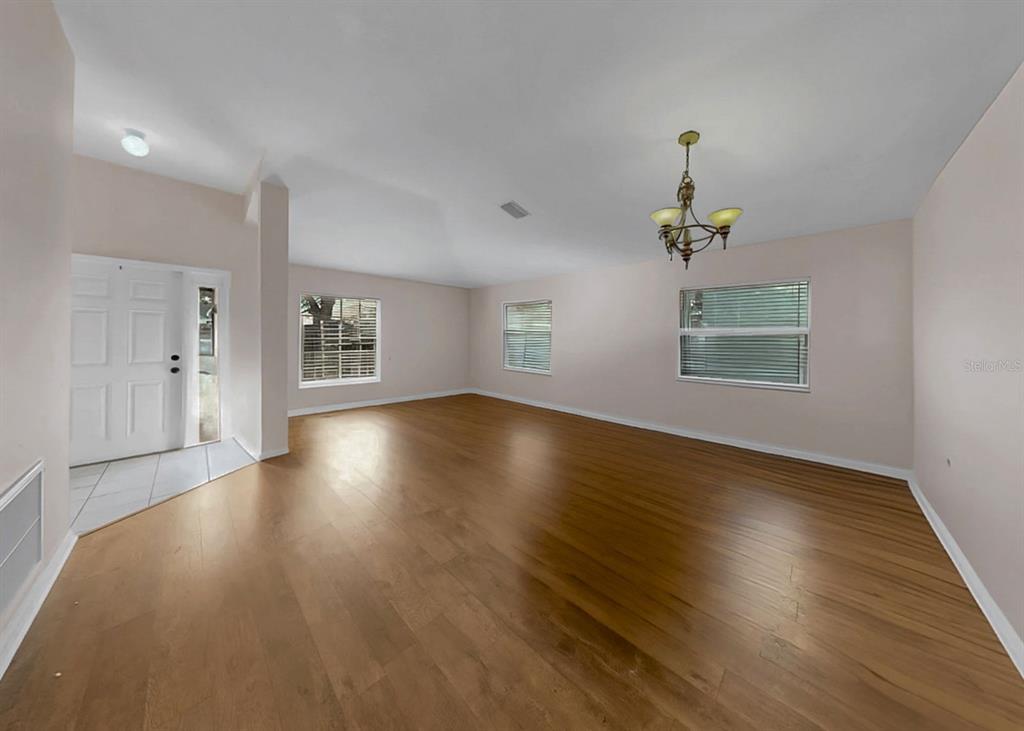 2310 Potomac Mark Place Ruskin, FL 33570 - Photo 6 of 40 a view of an empty room with wooden floor and a window