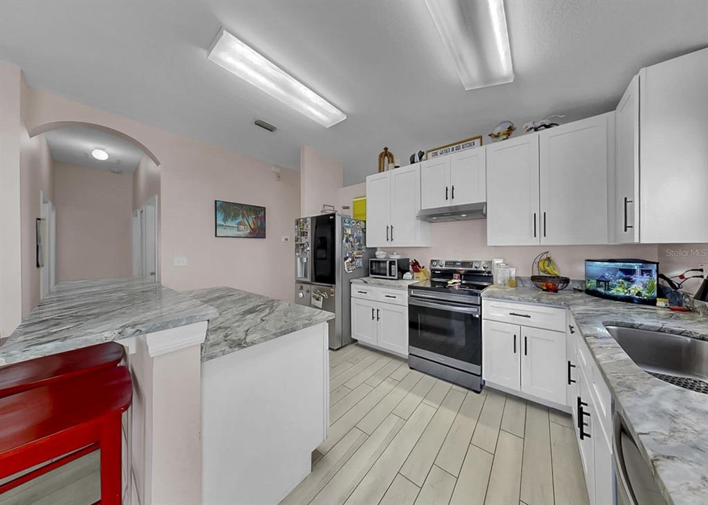 2310 Potomac Mark Place Ruskin, FL 33570 - Photo 7 of 40 a kitchen with granite countertop cabinets stainless steel appliances and a counter space