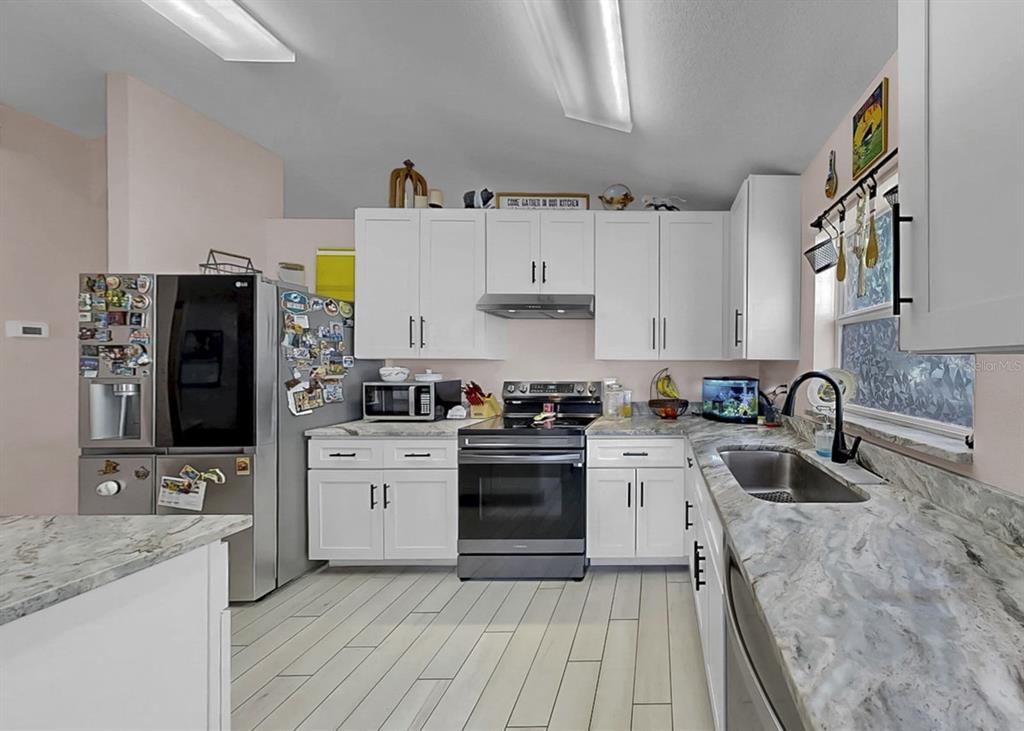 2310 Potomac Mark Place Ruskin, FL 33570 - Photo 9 of 40 a kitchen with a sink stove and refrigerator