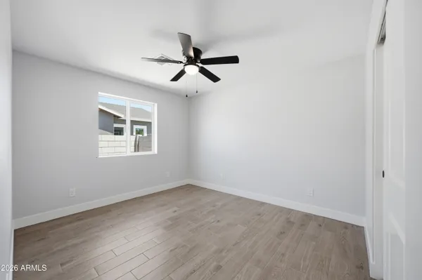 a view of a room with wooden floor and windows