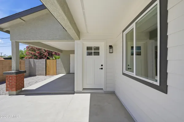 a view of a hallway with wooden floor and entryway