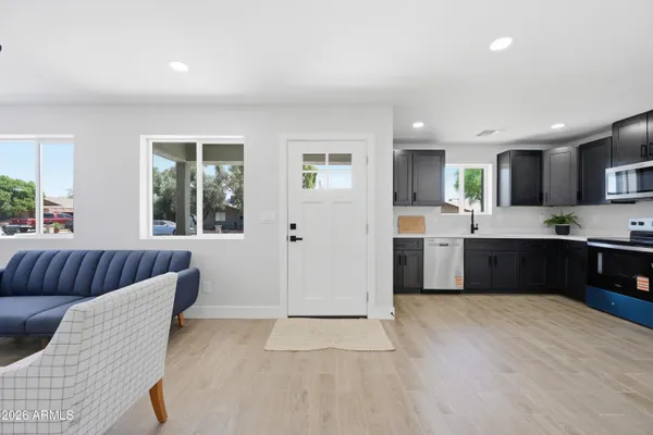 a large kitchen with a large window and stainless steel appliances