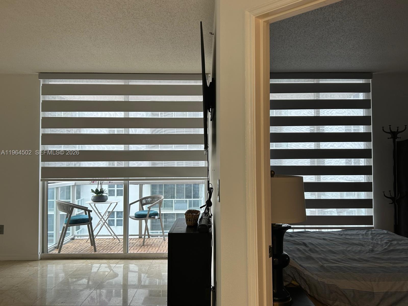 5077 Northwest 7th Street, Unit 1012 Miami, FL 33126 - Photo 9 of 15 a view of a room with a door and windows