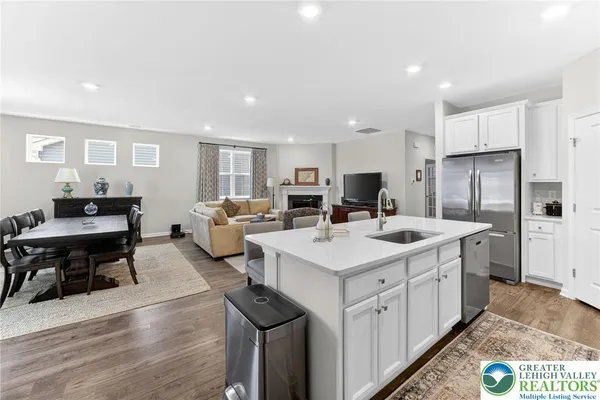 a kitchen with counter top space a sink appliances and cabinets