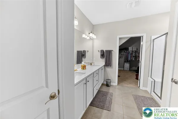 a bathroom with a double vanity sink and a mirror