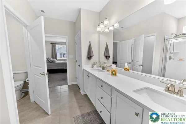 a bathroom with a double vanity sink mirror and