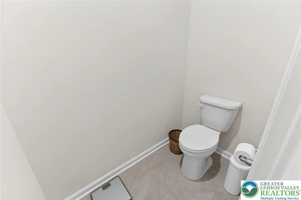 a white toilet sitting in a bathroom and a sink