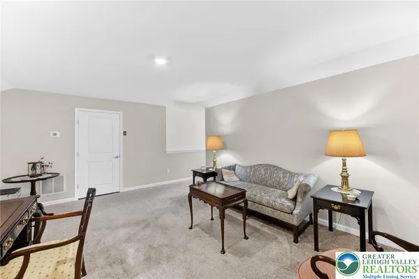 a living room with furniture and a lamp