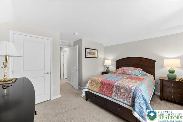 a bedroom with a bed and lamp