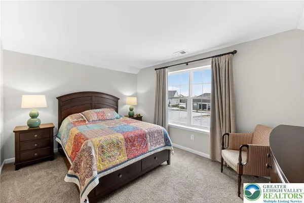 a bedroom with a bed chair and a window