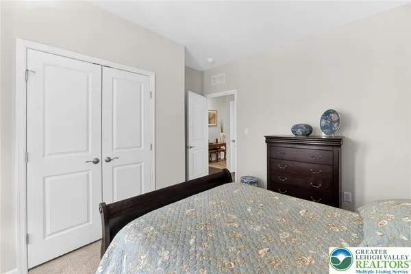 a bedroom with a bed and a dresser