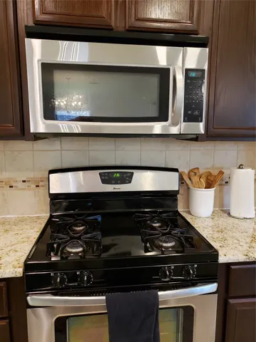 a stove top oven sitting inside of a kitchen
