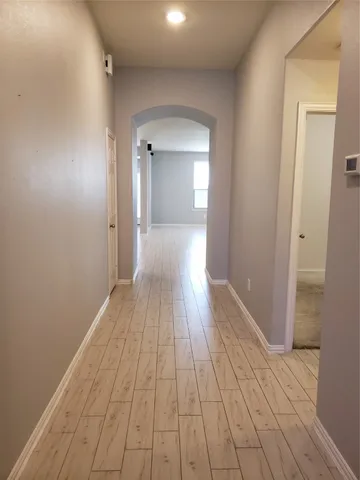 a view of a room with wooden floor and staircase