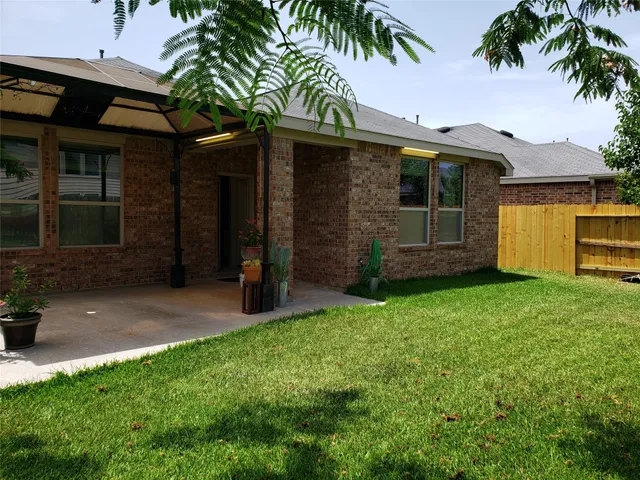 a view of a patio with table and chairs and potted plants