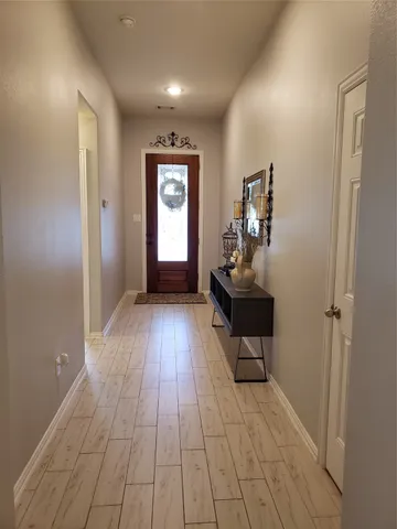 a view of a room with wooden floor and windows