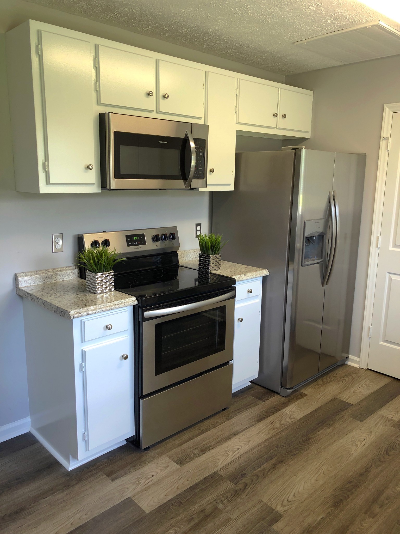 672 Crescent Road Murfreesboro, TN 37128 - Photo 8 of 20 a kitchen with stainless steel appliances a stove a microwave sink and refrigerator