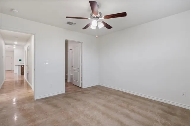 a view of an empty room and a ceiling fan