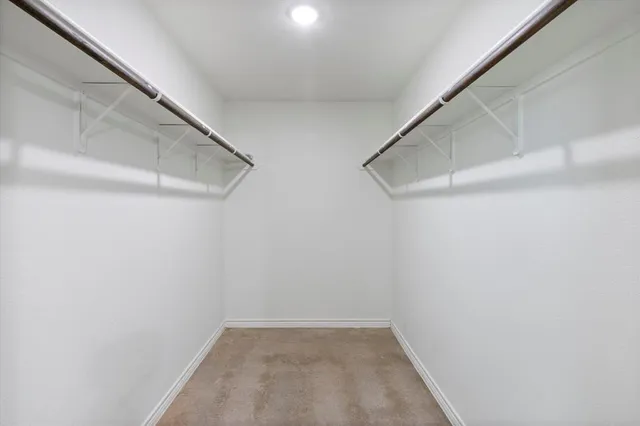 an empty room with fan and entrance