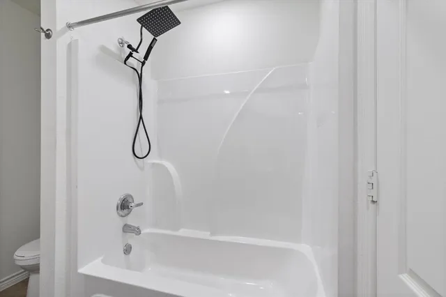 a bathroom with a granite countertop sink a mirror and a shower