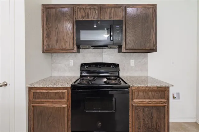 a view of kitchen with kitchen island a sink stainless steel appliances and cabinets
