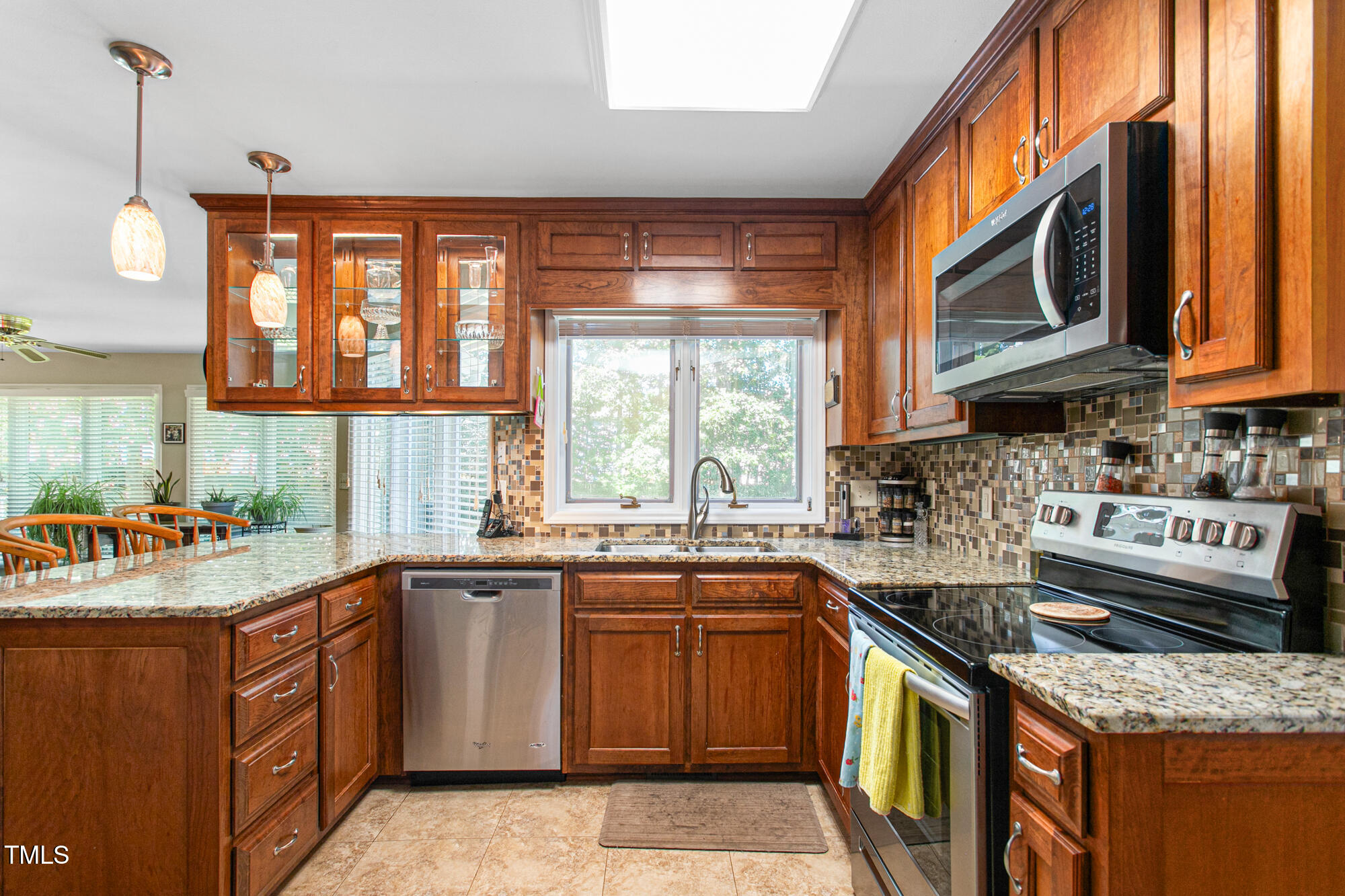 809 Brookview Drive Elon, NC 27244 - Photo 14 of 53 a kitchen with stainless steel appliances granite countertop a sink stove and cabinets