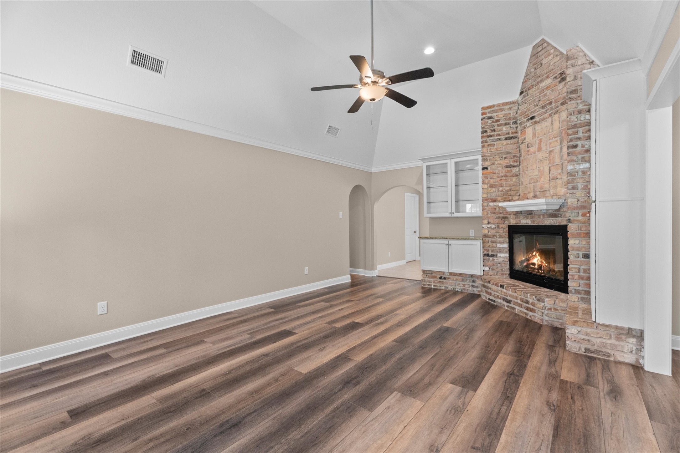 6530 Bayonne Drive Spring, TX 77389 - Photo 22 of 37 a view of an empty room with wooden floor fireplace and a window
