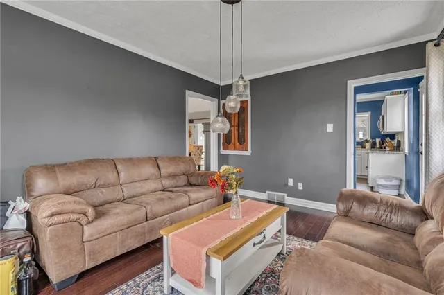a living room with furniture and a chandelier