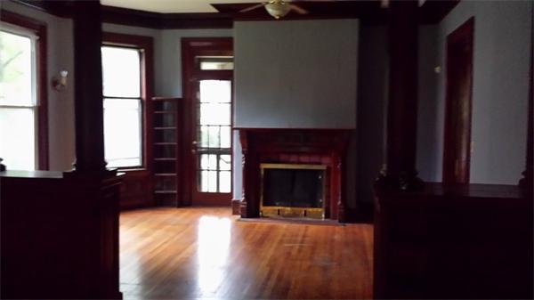 62 Westminster Street Springfield, MA 01109 - Photo 3 of 8 a living room with a fireplace and windows