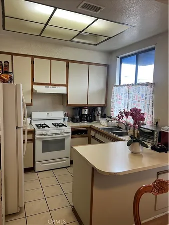 a kitchen with a sink appliances and cabinets