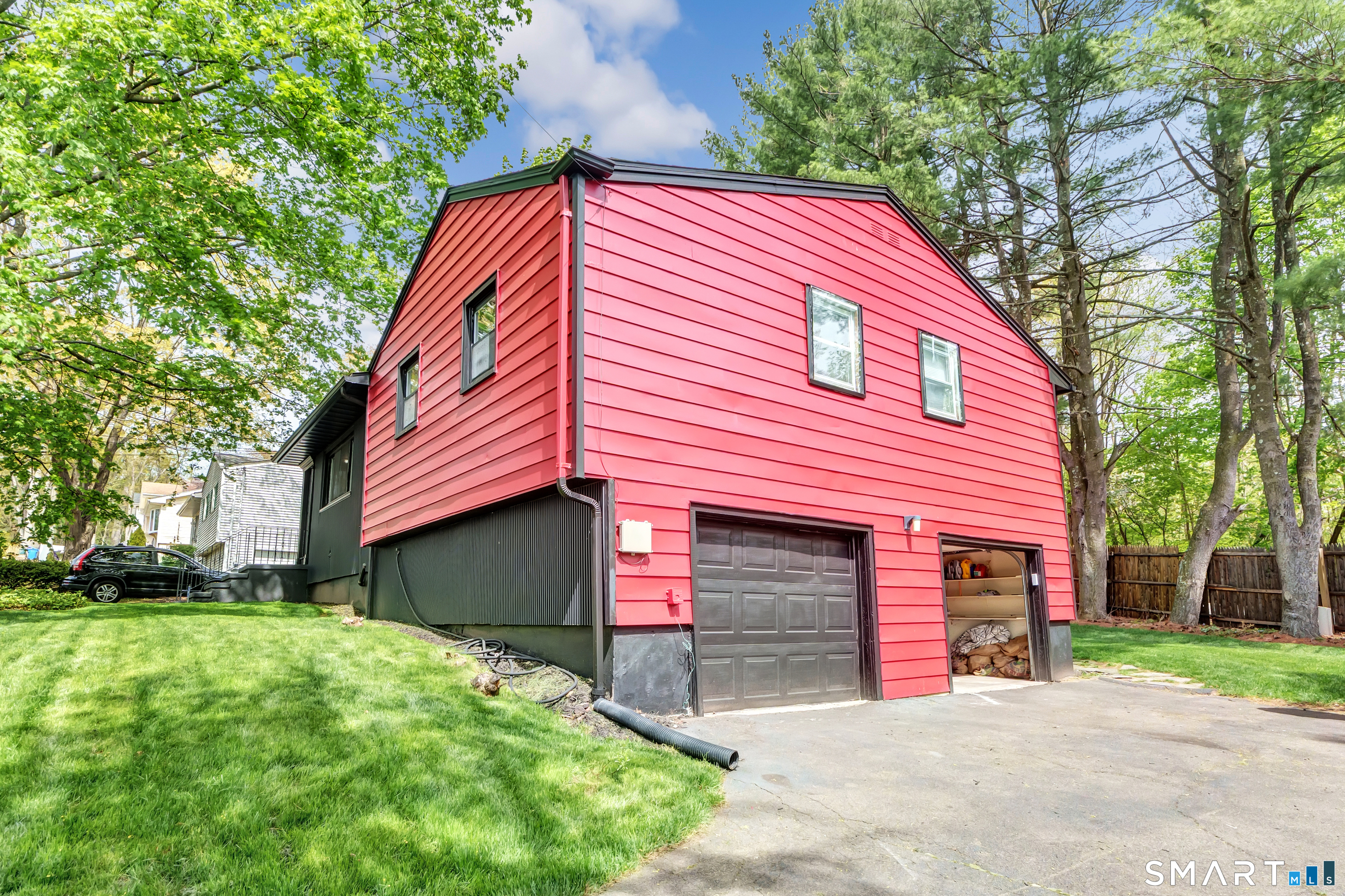 136 Harrison Drive Hamden, CT 06514 - Photo 2 of 20 a front view of a house with a yard and garage