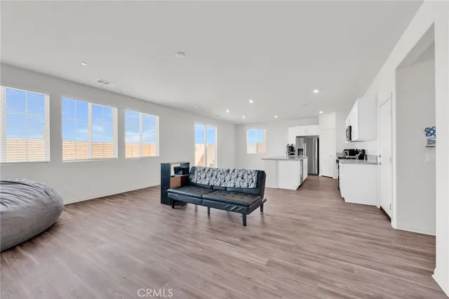 a kitchen with white cabinets and appliances