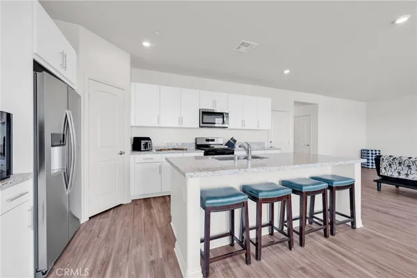 a kitchen with stainless steel appliances granite countertop a sink and a stove