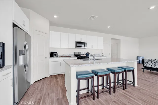 a kitchen with stainless steel appliances granite countertop a sink and a stove
