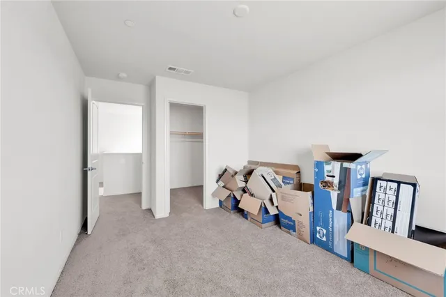 a white bath tub sitting next to a white toilet and vanity