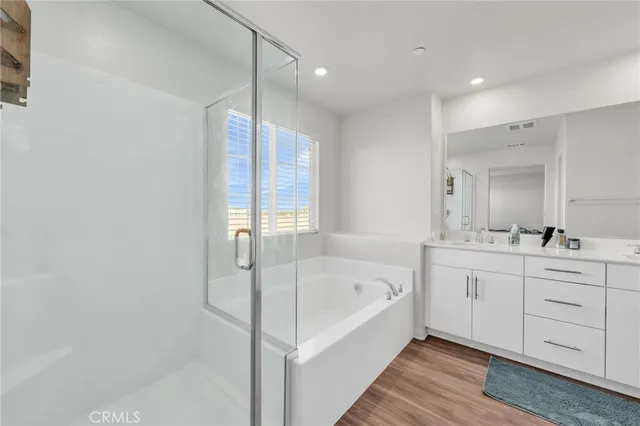 a bathroom with double sink and a mirror