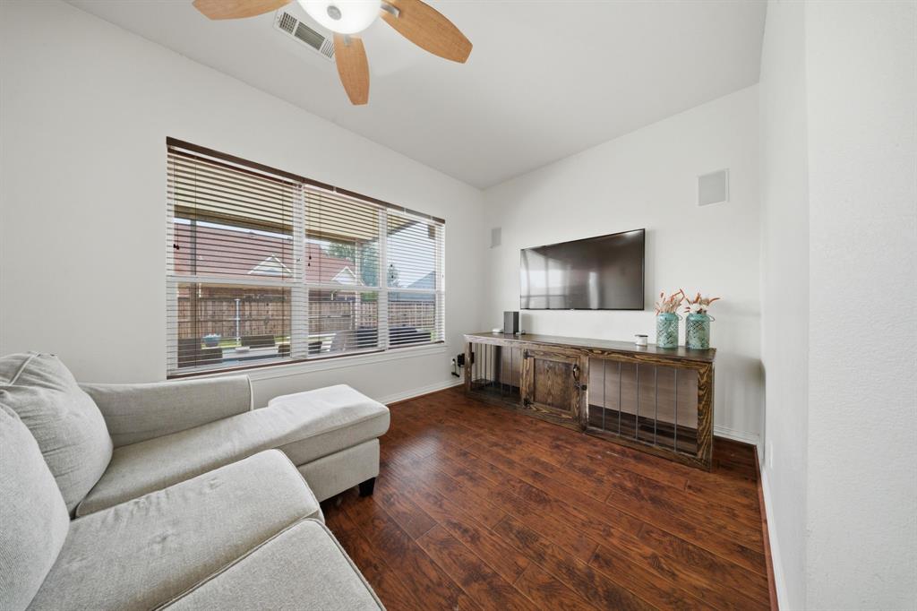 603 Cedar Drive Pilot Point, TX 76258 - Photo 21 of 39 Living area featuring wood-finish flooring and a ceiling fan with light fixture