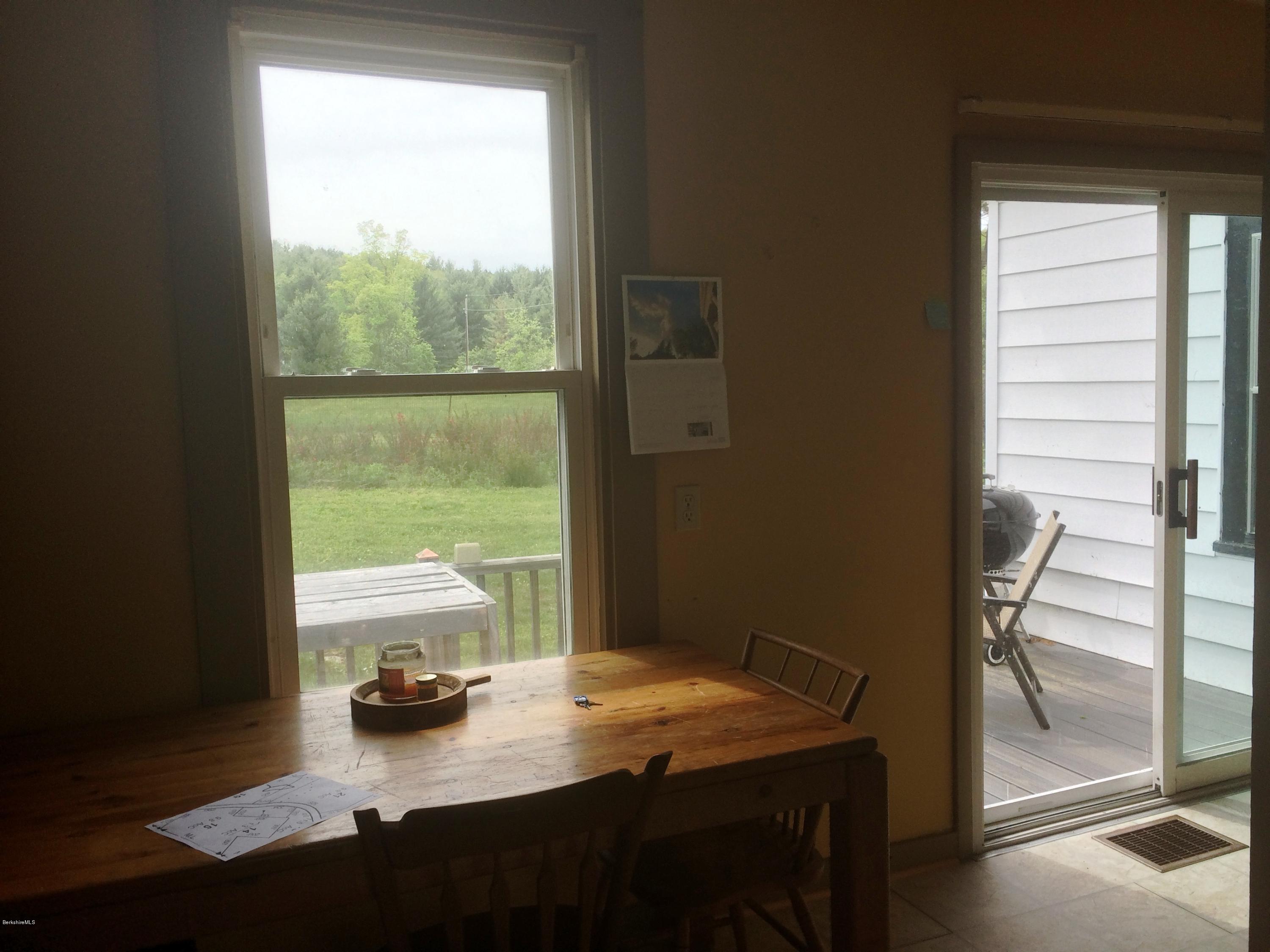 1124 Bancroft Road Becket, MA 01223 - Photo 14 of 23 a bed sitting in a bedroom next to a window