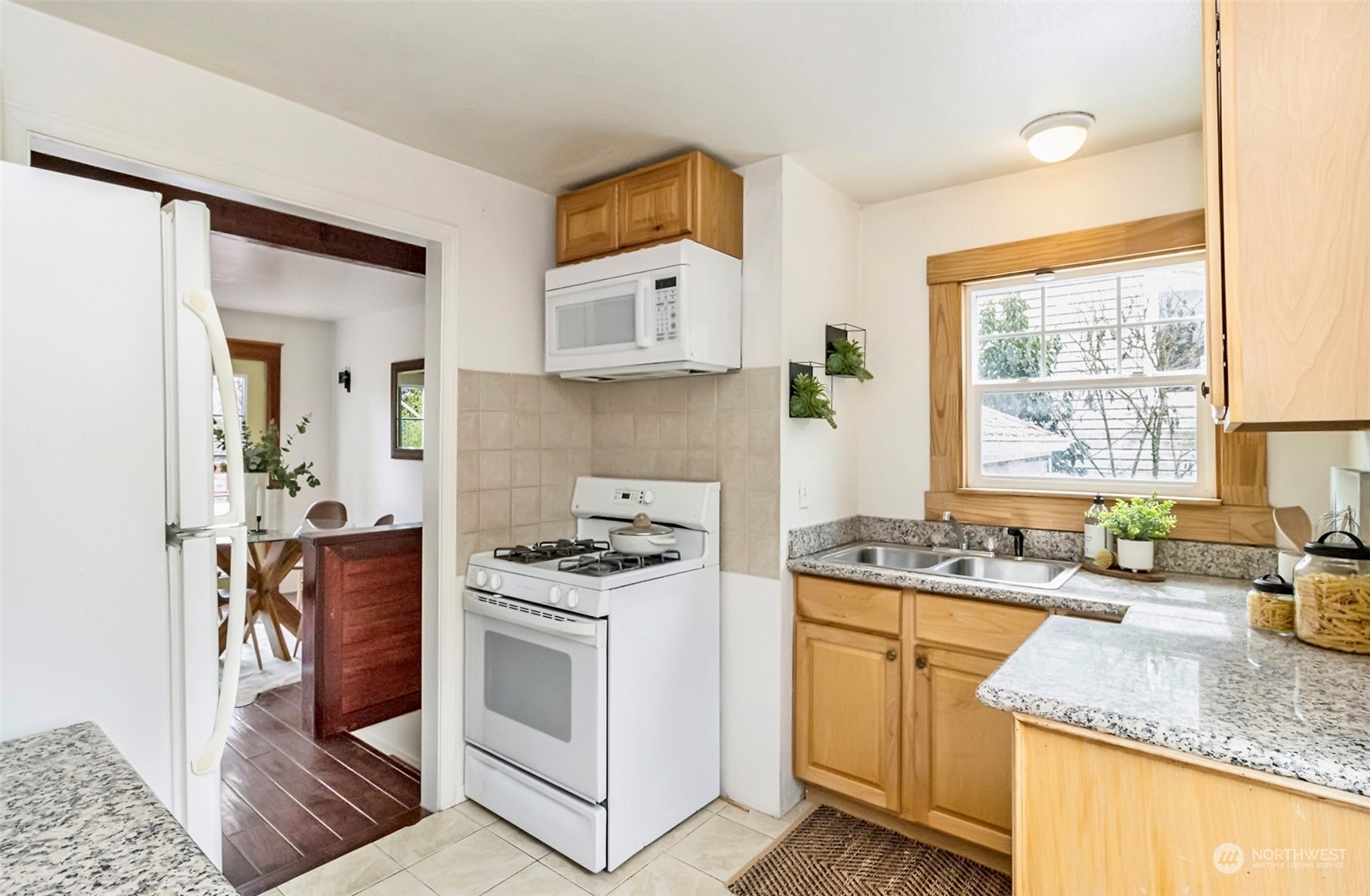 9048 3rd Avenue South Seattle, WA 98108 - Photo 35 of 36 a kitchen with stainless steel appliances granite countertop a stove a sink and a microwave