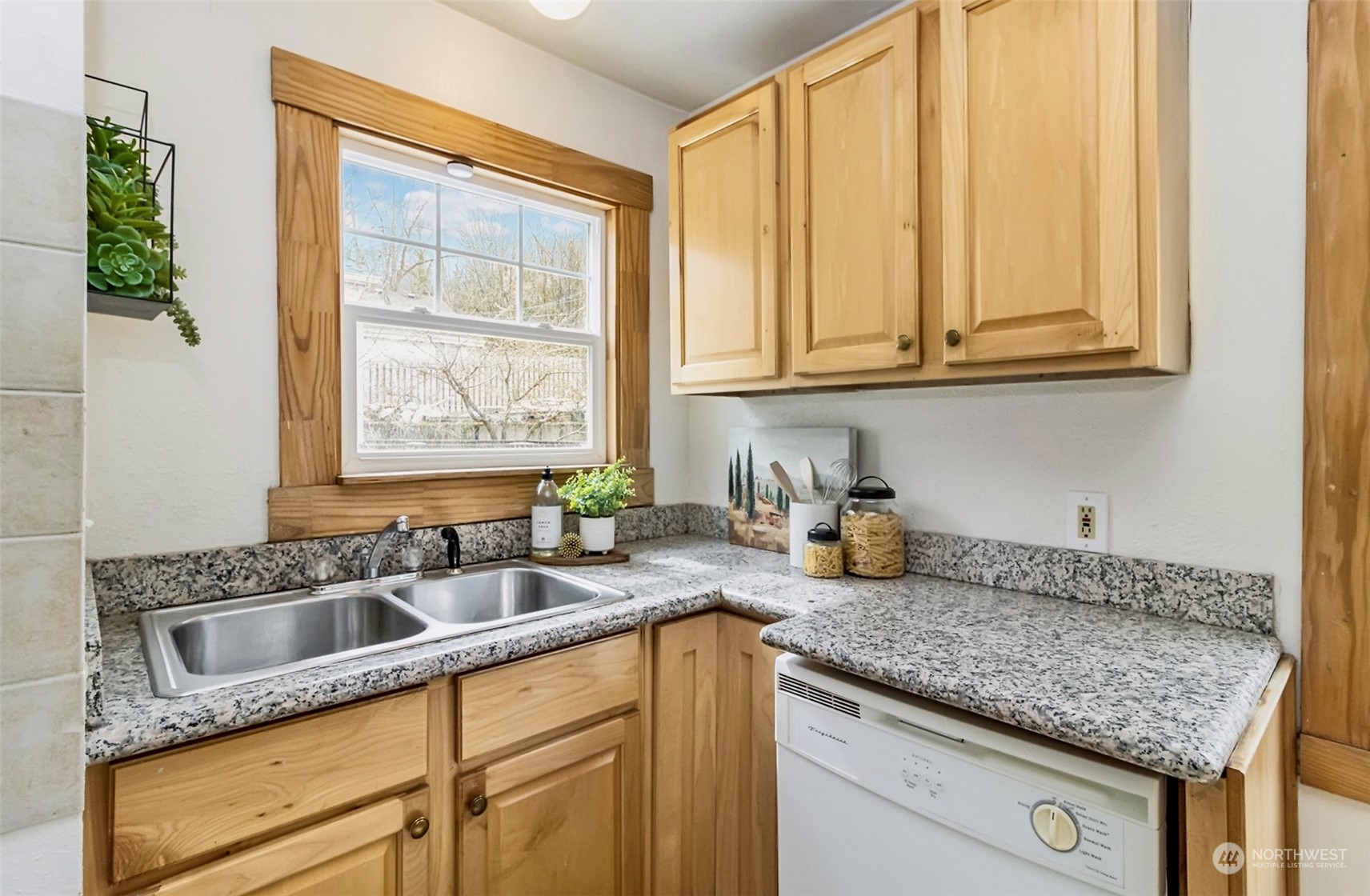 9048 3rd Avenue South Seattle, WA 98108 - Photo 9 of 36 a kitchen with granite countertop a sink a stove and cabinets