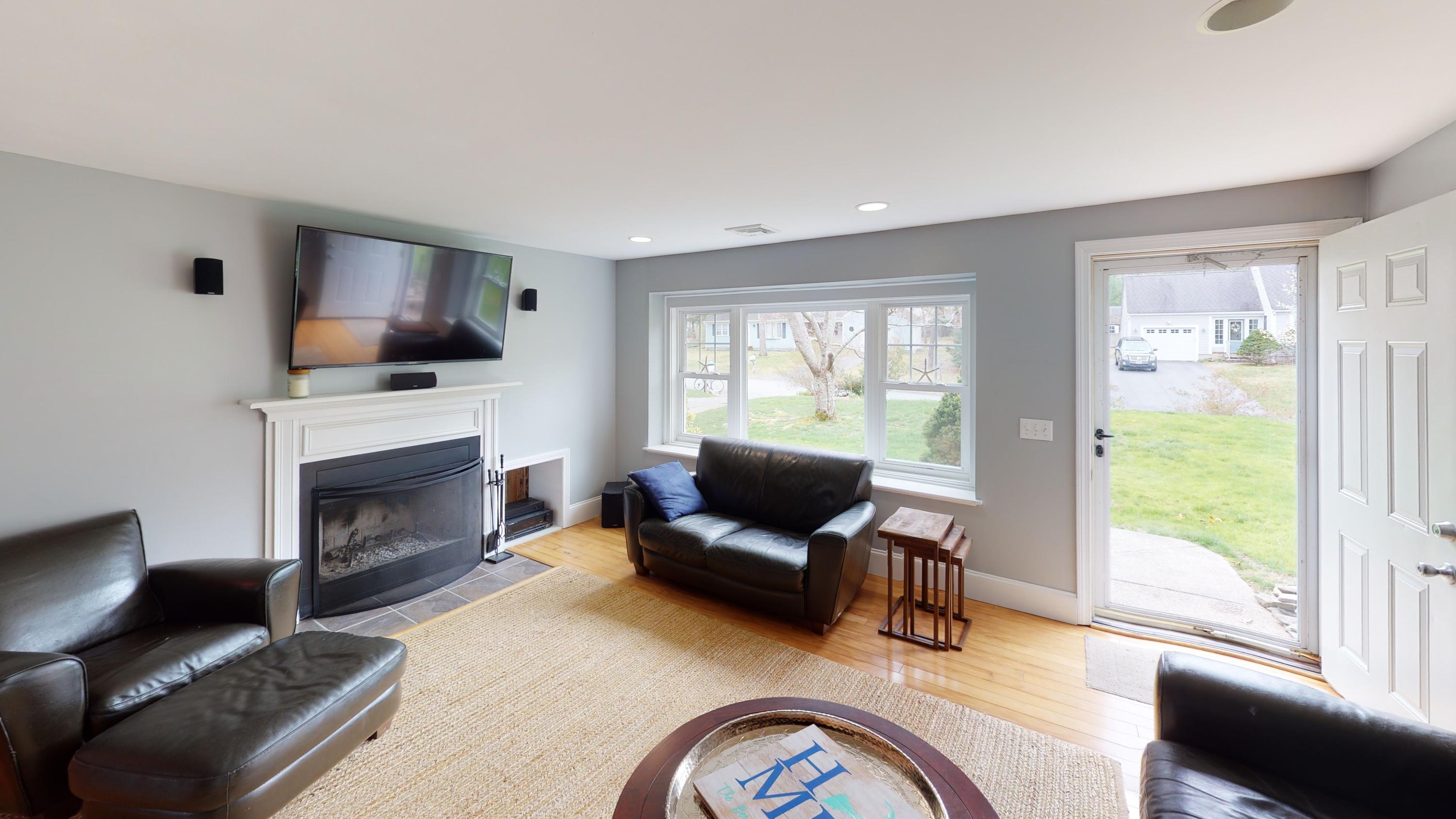 116 Oldham Road Osterville, MA 02655 - Photo 20 of 29 a living room with furniture a fireplace and a flat screen tv