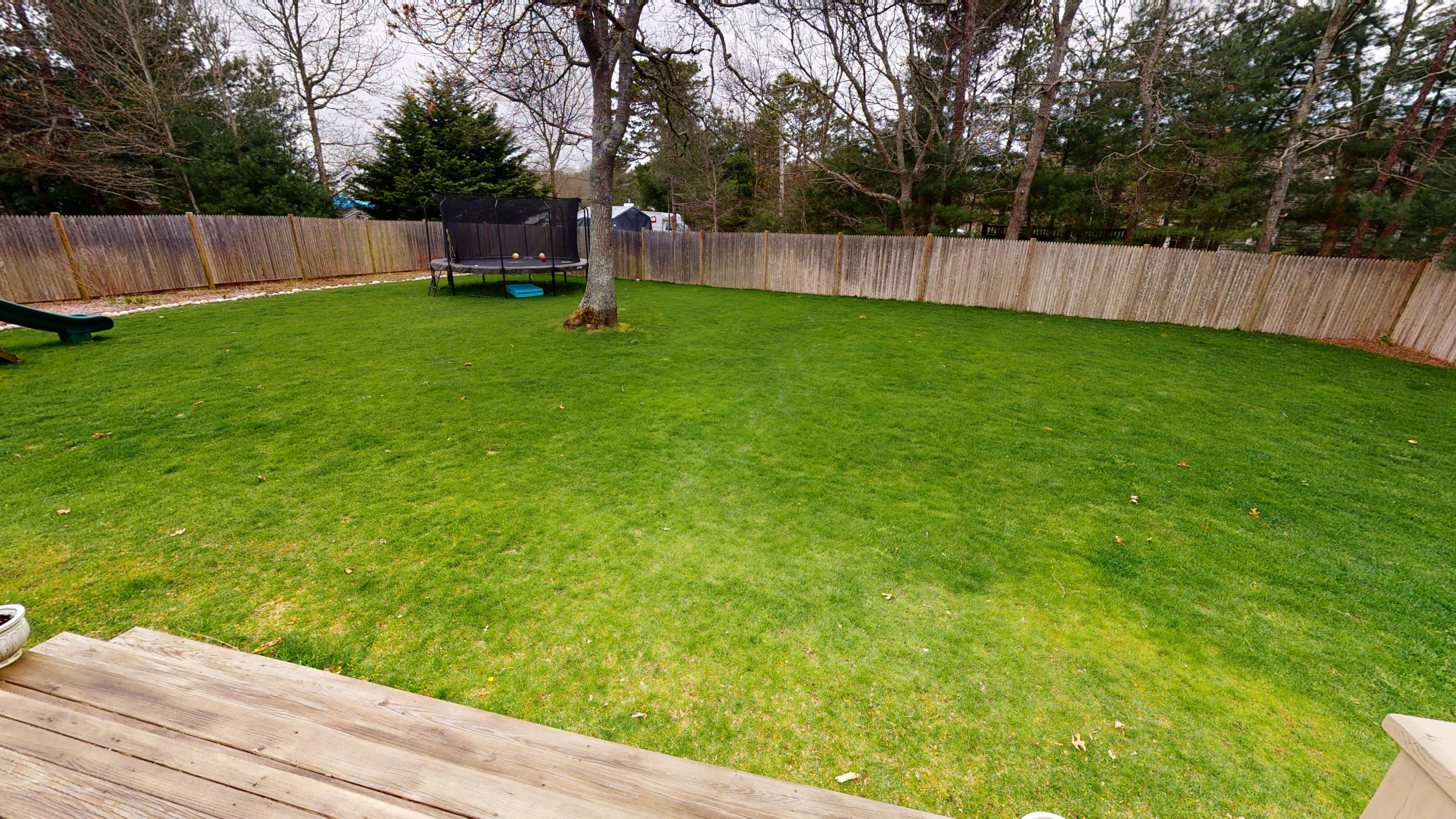 116 Oldham Road Osterville, MA 02655 - Photo 23 of 29 a backyard of a house with wooden floor and fence