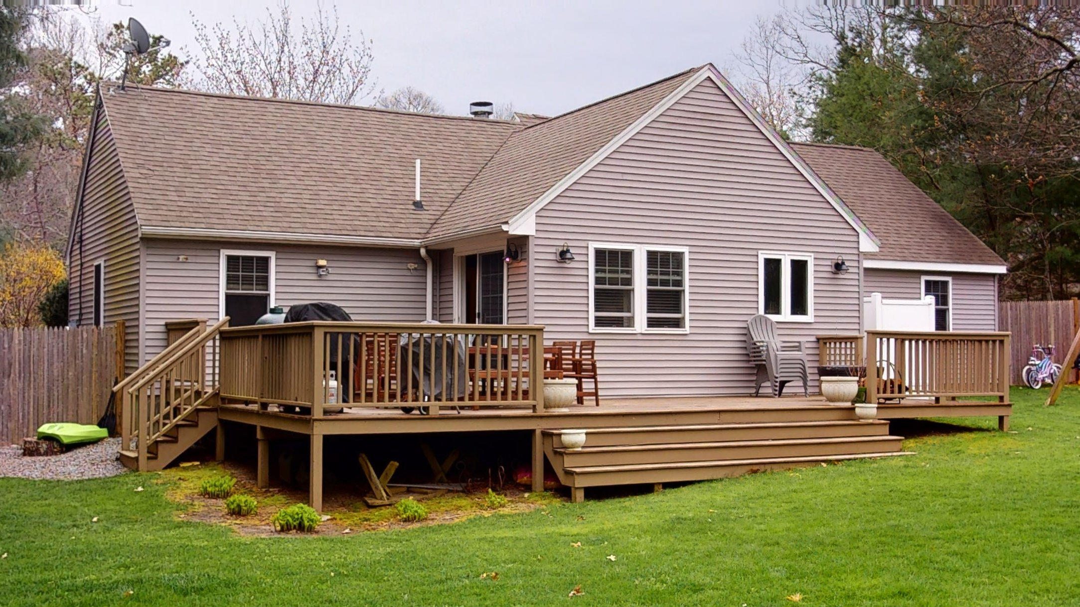 116 Oldham Road Osterville, MA 02655 - Photo 27 of 29 a view of a house with a small deck and a yard