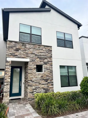 a stone house with a door and a yard